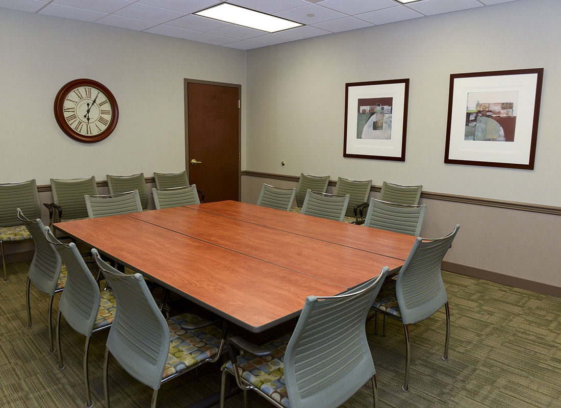 The Arbor Foundation - View Inside an Empty Meeting Room with Chairs Around a Large Wooden Desk in the Arbor Insurance Group Office