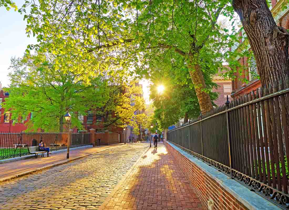 Nazareth PA Insurance - Romantic sunset viewed through the tree leaves in old city centre